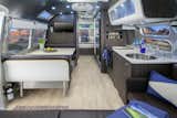 The 28-foot Airstream International Series features interiors by Christopher C. Deam. It sleeps up to six people and includes camping chairs, a gas grill, kitchen amenities, and bike rack.