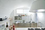 In acclaimed Italian designers Ludovica+Roberto Palomba's minimalist kitchen: sleek steel cabinet systems and a Kono range hood from Elmar. The multi-functional stainless steel island measures 20" deep.
