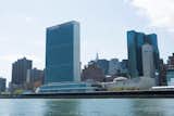 The United Nations makes a strong riverside presence. In the foreground, the UN Headquarters built with contributions by Wallace K. Harrison, Le Corbusier, Oscar Niemeyer, and Sven Markelius. Behind and to the right of the campus, the UN Plaza Offices and Hotel by Roche Dinkeloo.