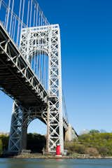 The George Washington Bridge towers over the Little Red Lighthouse. The lighthouse was popularized by a 1942 children’s book and in 1951, public outcry prevented its dismantling. It is listed on the National Register of Historic Places.