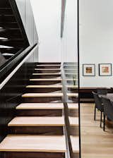 Staircase and Metal Railing The fireplace surround and staircase are fabricated from steel with a clear coat. Enclosed with glass on two sides, the space allows nature to flow inside.  Photo 4 of 11 in This Woodland Home in Virginia Was Built for Modern, Multigenerational Living