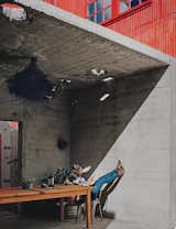 Kiyoko Loh relaxes inside a concrete structure, one of three original buildings that occupied the San Francisco property she and her husband, Elliot Loh, purchased in 2012. Working with architect Todd Davis, the couple decided to cut the bunker-like edifice in half and use it as an outdoor dining area that opens to a courtyard.