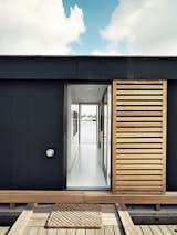 Outside, larch-wood shutters offer the residents privacy.