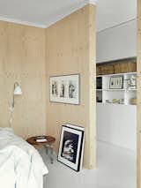 The sparsely decorated room features a PK33 stool, DUX bed, and framed photo of Björk by Anton Corbijin.