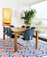 Dining Room, Table, Chair, and Pendant Lighting In this Issaquah, Washington, renovation, a Jill Rosenwald rug adorned with a blue-and-orange hexagons adds a vibrant note to the dining area.  Search “cut rug” from Modern Homes with Creative Floor Coverings 