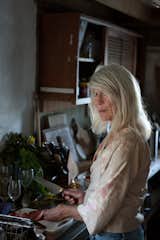 Local preparing a meal for one of the many bohemian dinner parties that take place at Athfield House in Wellington, New Zealand from Simon Devitt's new book Portrait of a House.