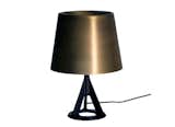 Base Table Light by Tom Dixon The Base Table Light is cast in rough iron and the brass shade is worked into a satin finish to create a soft, evenly dispersed light. $540