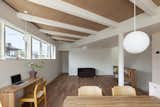 The ceilings of the two houses were at slightly different heights, an incongruity Nakasi played up for visual punch. He exposed the beams in the higher ceiling and painted them white to match the smooth finish of the lower one. The desk beneath the window is from Muji.