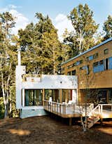A prefab unit built from red cedar features several decks, which wrap around the homes structure. Photo by: Roger Davies
