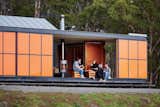 The Premaydena House by Misho+Associates was designed as a "box within a box," in which two interior structures—an open-plan living space and two en suite bedrooms—sit within an exterior envelope. Inspired by the region’s fiery orange lichen and the indigenous waratah shrub’s bright flowers, the colorful exterior panels are made of heavy-duty galvanized steel to guard from Tasmanian winds, which can reach up to 60 miles per hour.