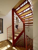 Fabricated by Stocklin Iron Works and designed by Nebolon, the orange staircase features steel railings and treads made from IKEA wood butcher blocks. “We designed the open staircase to make the trip to the second floor fun,” the architect says.