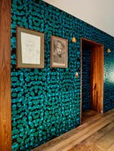 The once public hallway between the two apartments now boasts a bold wallpaper by Kravitz Design for Flavor Paper.