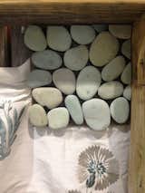 Natural pebbles join fabric on Broeder’s board.