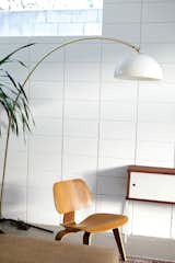 The living room is populated with a molded plywood Eames chair and a vintage Italian lamp.