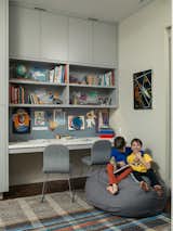 Houldin, 10, and Jonas, 8, in the boys' shared work area-slash-playroom. The vintage kilim rug was purchased at Double Knot and the desk chairs are by Jasper Morrison for Cappellini.  Photo 7 of 7 in Kids/Play by Michael Bradley