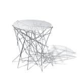 Designers Fernando and Humbert Campana conceived this prism-like table in 2004 for Alessi using a collection of welded stainless steel rods to create the base. The tiny table is but one piece in their Blow Up collection, which also includes accessories such as clocks, centerpieces, and magazine racks. Available from Zwello.