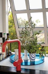 A red Vola faucet adds color, while the muntin bars on the windows recall the originals.  Photo 7 of 12 in A Cramped Attic Became a Sunny Dining Room in this Renovation of a Copenhagen Tudor