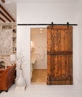 The Brooklyn Home Company renovated a Brooklyn, New York townhouse, contrasting a modern interior with reclaimed materials. The bathroom door pictured here was originally the barn door of a New Hampshire sheep farm.  Photo 3 of 6 in Amazing Repurposed Designs by Emma Marsano