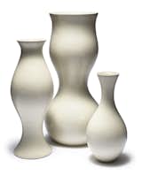 Designed in collaboration with legendary designer and longtime friend Eva Zeisel, KleinReid’s Eva collection is comprised of handmade porcelain vases in several sizes. Of her many accomplishments, one of Eva Zeisel's most noteworthy contributions to the design world was helping to bring the work of female artists to the forefront. Each vase features gentle curves that move from the slender, simple form of the petite bud vase to the more curvaceous, bulbous form of the large vase.  Search “porcelain-bud-vase.html” from Modern Vases for Summer Blooms