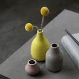 The Botanica Bud Vase Trio is a charming collection of three small vases, cast in an inviting palette of grey, yellow, and pink. These petite vases are designed to hold a large single bloom or a few buds with thin stems. The smallest vase in the trio has the widest mouth, and can hold several shallow flowers. The trio can be grouped as a traditional centerpiece or collected together on a mantel, and can also be separated and used in different parts of the home to create small accents wherever a cheerful accessory is needed.