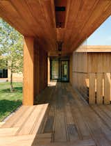 Contractor Keith Romeo worked with Bates Masi on the varied mahogany planks used for the exterior decking, which are finished simply with wood toner by Cabot.  Photo 8 of 9 in Modern Wood-Lined Family Home in the Hamptons
