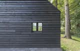 In keeping with Scandinavian building traditions, locally sourced Douglas fir clads the exterior. "The clients like the simplicity of [local] barns," Koolhaas says. The black paint also helps draw in heat, which is important in the region's cold climate.