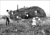 When settlers first made their homes on the prairies of North America, the sod house was the prevalent form of architecture because wood wasn’t readily available. Settlers cut patches of sod into long rectangles and layered them together to form small huts. Photo via schmidt-thesman.blogspot.com