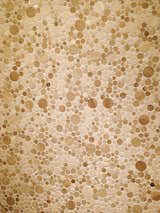 The Moon Stone Mosaic design features various circular wooden "moons."  Search “kitchencounters--stone” from Porcelanosa Tile Showroom Visit