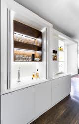 Exterior doors slide open and tuck to the side to reveal shelving for liqour bottles and glassware and a beer tap. "When you're designing a kitchen you can get away with a lot more because there is an expectation that it's a functional space," Chen says. "But in a thing like a bar—particularly one that isn’t active all the time—I think there’s a pretty big challenge to incorporating the service aspects without it reading like a kitchen."