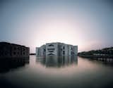 Originally meant as a Pakistani government building, Kahn's monumental design became the seat of the government of Bangladesh when the country split in two. It's as bold and commanding a symbol of young democracy as the world has ever seen; eight concrete modules envelop a center space cloaked in white marble, while the surrounding artificial lake provides natural cooling and a dramatic backdrop.