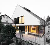 Sky-high ceilings are created by a sculptural pitched roof. Its uneven angles are the result of the required setback distances from surrounding roads and houses.  Photo 17 of 70 in House of the Week by Matthew Keeshin from House of the Week: Minimalist Dream Home with an Asymmetrical Pitched Roof