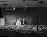 City Parks Commissioner Robert Moses and Walt Disney examine plans of the 1964 World’s Fair Grounds.