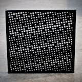 The houndstooth in the Houndstooth Valet comes in the perforations of the acrylic panels. It's a nice nod to menswear while also lightening up what could be a flat black surface.  Search “jeeves wall valet” from Valet Houndstooth by Atelier-D