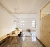 A set of birch plywood pieces, used to create sliding doors, benches, and storage, added subtle accents and maximized the space. The apartment features a very open floor plan centered around the custom dining room table.  Search “renovating old and new barcelona” from 1930s Barcelona Apartment Gets a Minimal Makeover