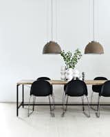 Morten Bo Jensen, of Danish industrial design company Vipp, and his partner, graphic designer Kristina May Olsen, have mixed repurposed vintage items with their own creations inside their Copenhagen apartment. In the kitchen, the dining table—Jensen’s first piece for Vipp—is made of a powder-coated aluminum frame with a recycled, untreated teak top. The lamps overhead are salvaged and rewired Copenhagen streetlights.