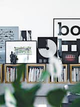 In the main living area, Olsen’s own artwork picks up on the graphic diversity of the magazines housed in Boox shelving by Jesper Holm.  Photo 3 of 8 in Converted Loft Fit for a Modern Family in Copenhagen