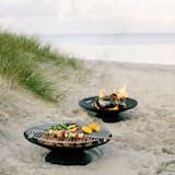 An innovative fire pit, the Helios Fire Bowl Set doubles as a grille, making it a smart addition to a backyard BBQ. Use the Helios with coals to grill meats and vegetables or with logs to create an inviting fire for s’mores.