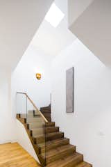 Here also hardy materials—the dark oak stairs—contrast with clean white walls.