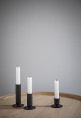The Luster Candle Holders create an instant statement on a mantel or tabletop, and can be arranged from shortest to tallest, in a cluster, or sporadically to create a distinctive, changing look. Each holder is defined by its geometric details—a cylinder meets a circular base. Crafted from a zinc alloy with a black matte finish, the luster candleholders blend a cool modern look with a traditional feel, making them a balanced accent for a variety of interiors.