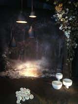 Designer Nicole Hollis was inspired by Litith Rockett's pendant light and bowls. This display in particular was an experience of the senses with rich textures, the smell of the dirt, and even sounds playing in the background.