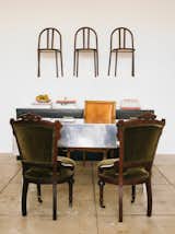 Chairs by Robert Mallet-Stevens hang on a wall near a vintage Army folding mirrored desk for Knoll.