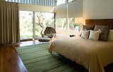 The enlarged master bedroom, which overlooks the backyard, features a bed and nightstands by David Albert Design, pillows by Madeline Weinrib, a Tibetan rug from Amadi Carpets, and Saarinen’s Womb chair and ottoman.