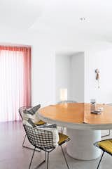 The couple has a fondness for mid-century designer Harry Bertoia, whose steel side chairs for Knoll ring the concrete dining table that they designed.