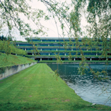 "Completed in 1971, the Weyerhaeuser Corporate Headquarters building in Federal Way, Washington — often called a "skyscraper on its side" — is composed of gently sloping landscaped terraces that step upward. At each level, deeply recessed windows run continuously along each side of the building, uninterrupted by wall surfaces or metal dividers. With lush vegetation spilling over the terrace walls, the building appears to merge with the surrounding environment. Weyerhaeuser Corporate Headquarters was the fourth SOM project to win The American Institute of Architects’s 25-Year Award when it was recognized in 2001."