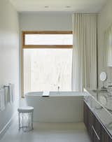 Bath Room, Freestanding Tub, and Wood Counter The master bathroom features Pro Tec windows framed in European pine, a freestanding tub by Wetstyle, and a marble vanity top from Ciot.  Photo 8 of 10 in On a Peaceful Wooded Lot, a Futuristic Toronto Home is Buzzing with Smart Tech