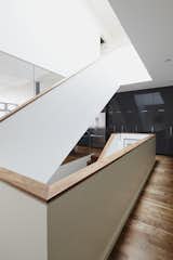 Architect Alexandre Blouin designed a rectangular staircase at the center of this house, positioning it beneath an operable skylight that draws in sunshine that otherwise would have struggled to penetrate the core of the building, which is 50 feet deep.