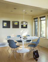 Dining Room, Pendant Lighting, Table, and Chair Inside the prefab residence, molded plastic Eames chairs from Design Within Reach rest beneath a Splugen Brau pendant light from Flos.  Photo 9 of 14 in A Homeowner Uses Smart Technology to Manage His Napa Property from Anywhere