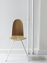 The chair is also available in a black or oak (shown) veneer.