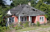 An derelict abandon house once sat on the plot of land. Here's what it looked like before. With the help of locals, artist Matthew Mazzotta demolished the house, saving materials where he could. Once everything that could be salvaged was set aside, the fire department burned the remainder.  Photo 3 of 8 in Watch an Unassuming House Unfold into a Community Theater by Diana Budds