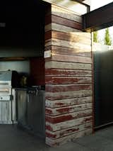 Developer Doug Burgum opted for locally-sourced reclaimed wood from a demolished barn to build sections of the pergola covering the cooking space.